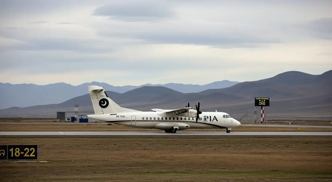 PIA turboprop aircraft parked at a remote mountain airport in Pakistan with flights temporarily suspended